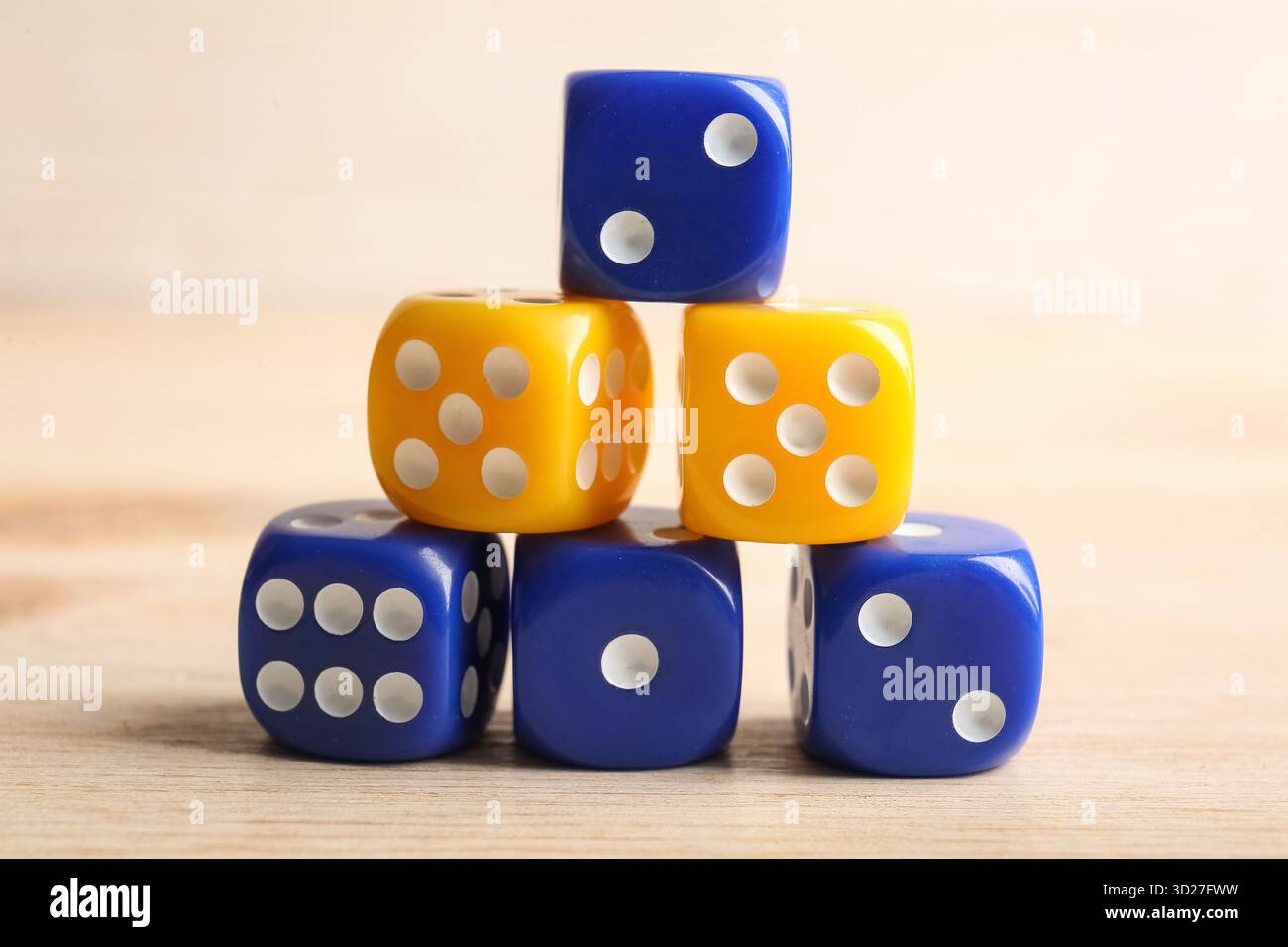 Stack of different game dices on wooden background Stock Photo
