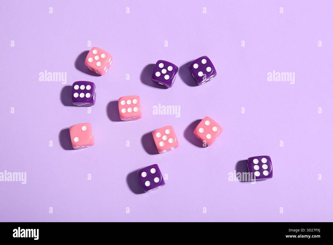 Different game dices on lilac background Stock Photo