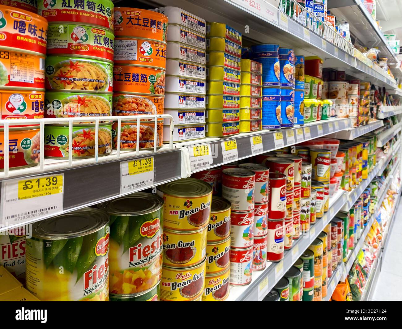 Canned foods on sale in an Asian supermarket in London, UK - Smartphone Captured Stock Image
