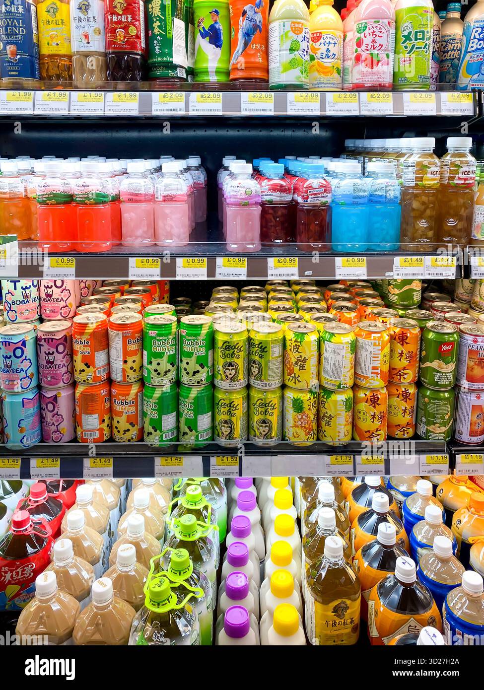 Bottles of cans of drink in brightly coloured, enticing packaging on shelves in an Asian supermarket - Smartphone Captured Stock Image