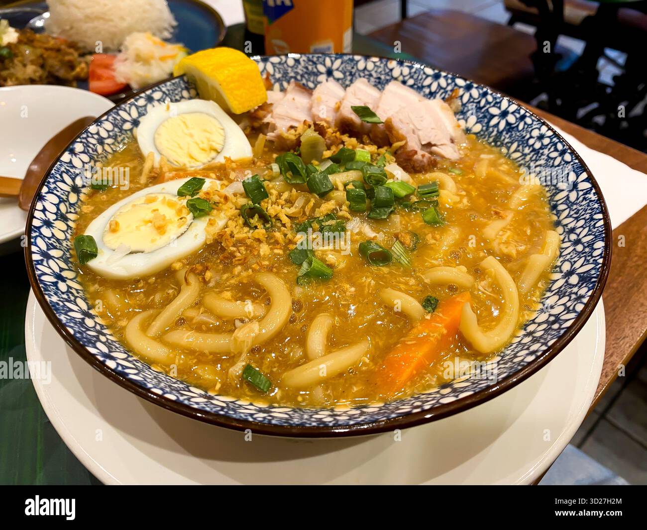 Pancit Lomi, a Filipino soup with noodles served here with fried belly pork and hard boiled egg. - Smartphone Captured Stock Image