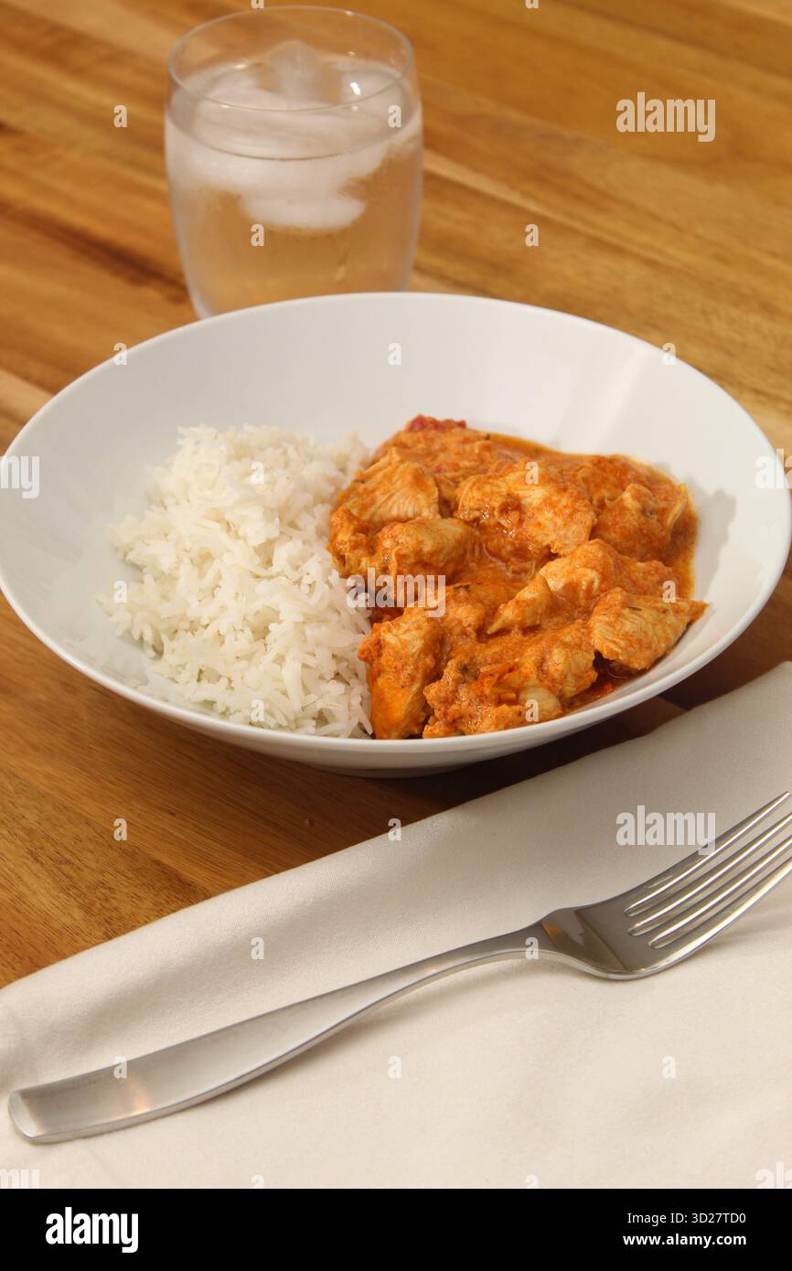 Close-Up of Prepared Chicken Curry and White Rice Dish Stock Photo