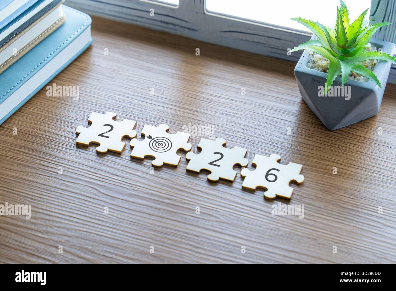 Wooden puzzle pieces arranged on a wooden desk forming the number 2026 ...