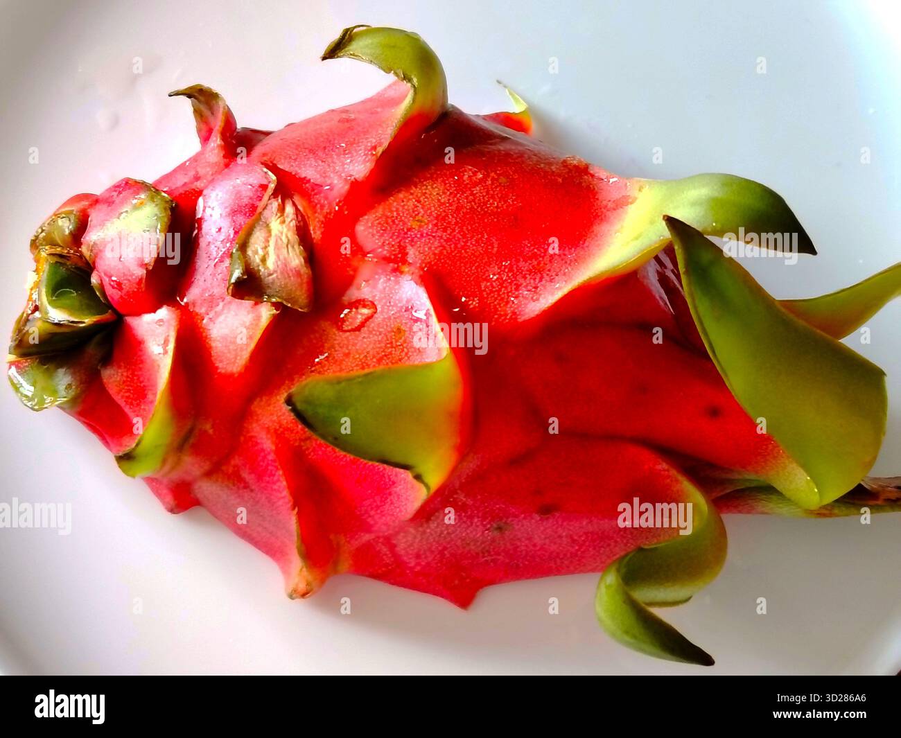Red dragon fruit on a white plate. Stock Photo