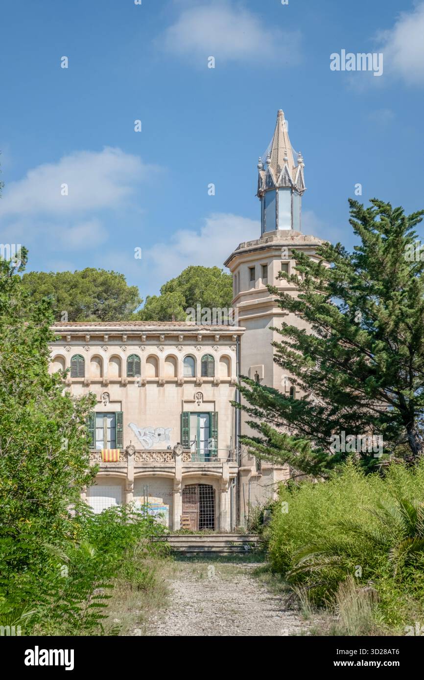 The decorative facade, arched gallery, and central tower of the abandoned Modernist Masia Cal Pla in Cunit, Tarragona, Catalonia, Spain Stock Photo
