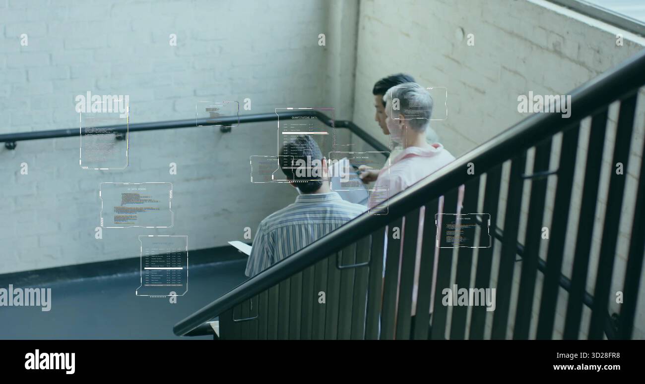 Collaborating developers viewing digital code overlays in office stairwell with tablet and railing Stock Photo