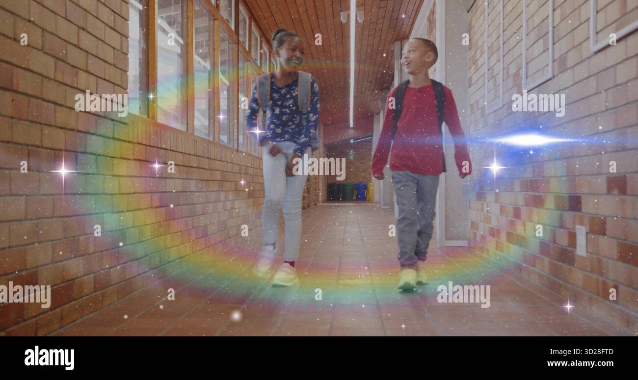 Walking two classmates carrying backpacks inside school hallway, with digital rainbow arc overlay Stock Photo
