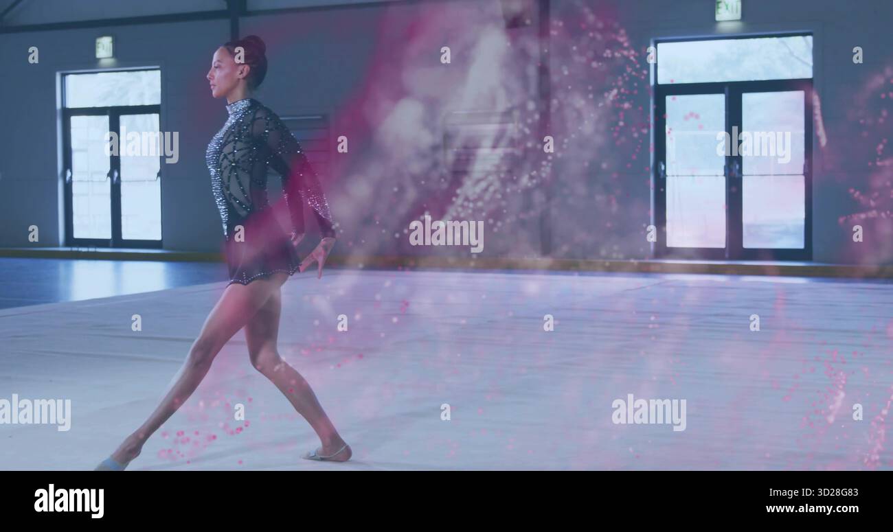 Performing gymnast wearing sparkly leotard lunging on gym mat in gym ...
