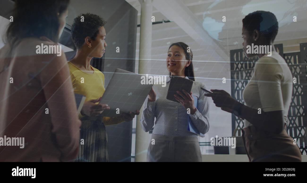 Discussing team projects using grid overlay in modern office, with laptop tablet smartphone folder Stock Photo