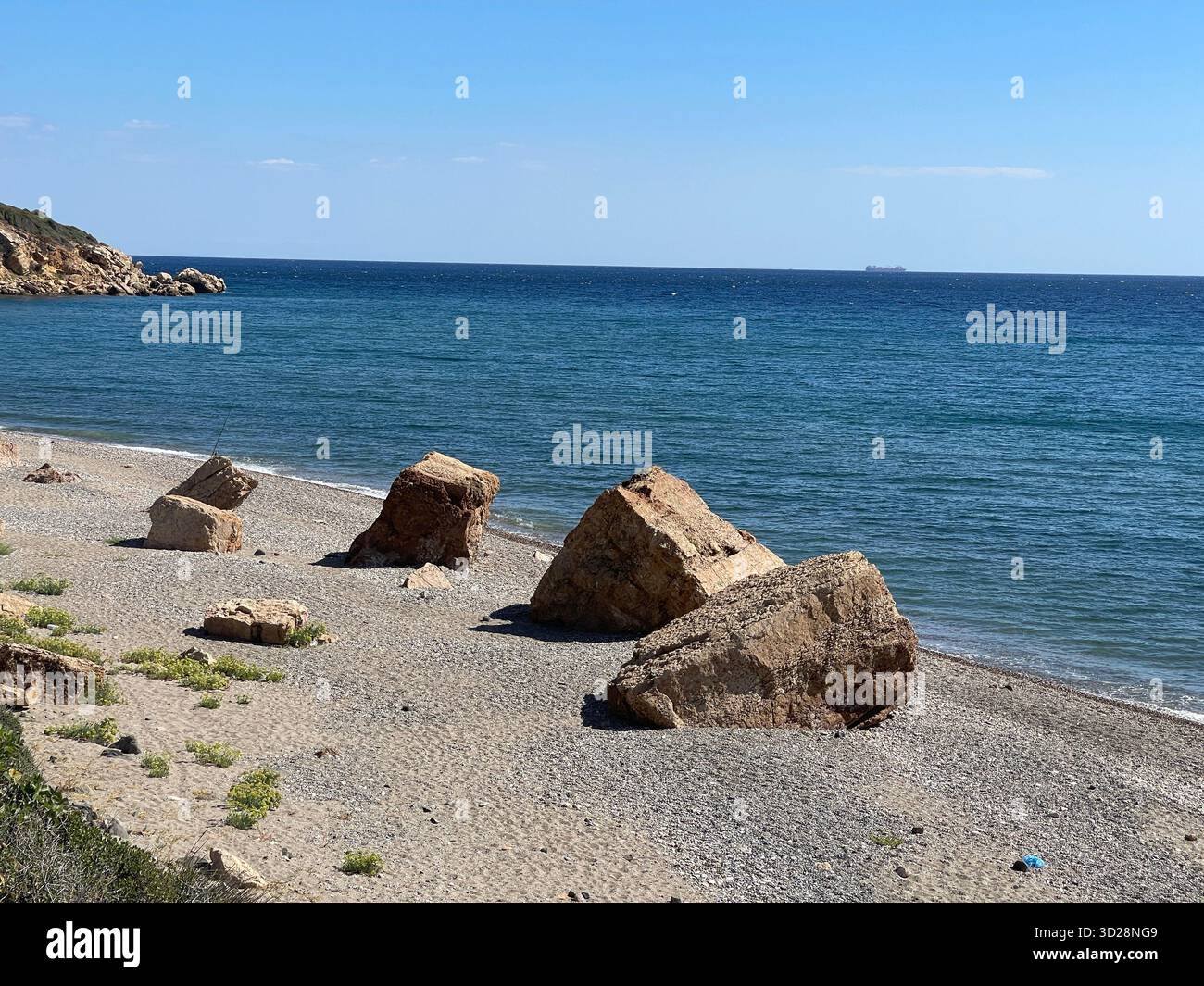 Beach at village Petrota with scattered stones, sunny day, Komotini, Thrace, Rhodope, Greece. - Smartphone Captured Stock Image