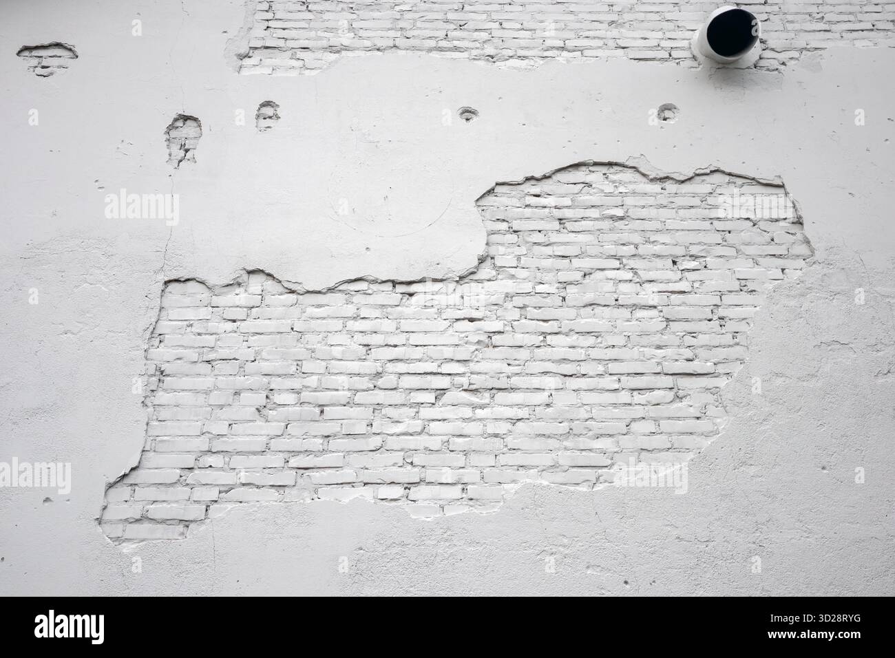 white painted brick wall with damaged plaster background Stock Photo