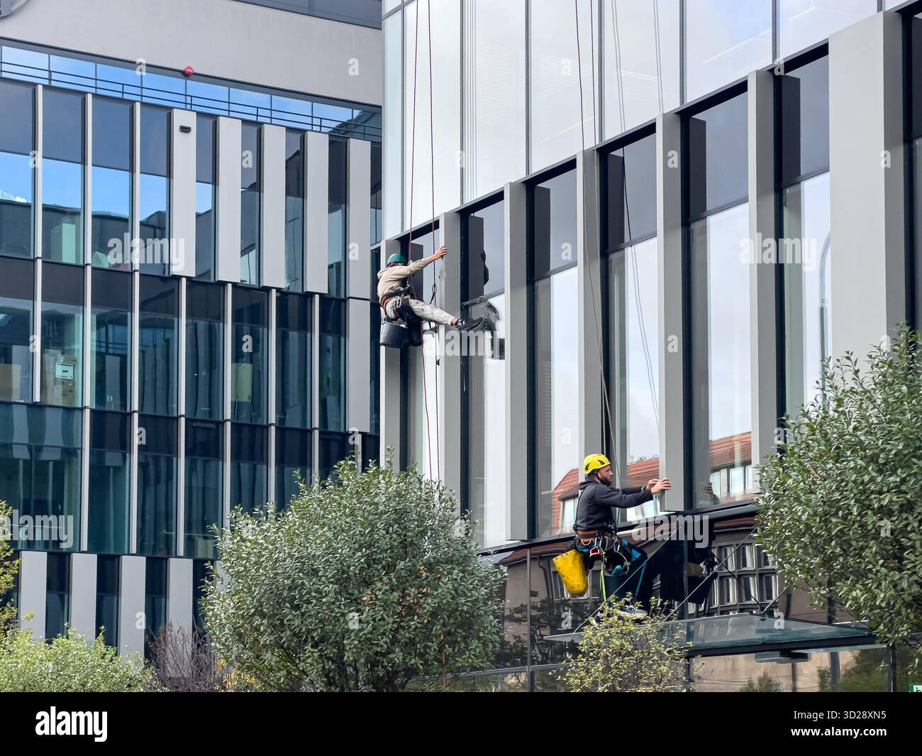 Poznan, Poland - October 10, 2025: Exterior maintenance professionals ...