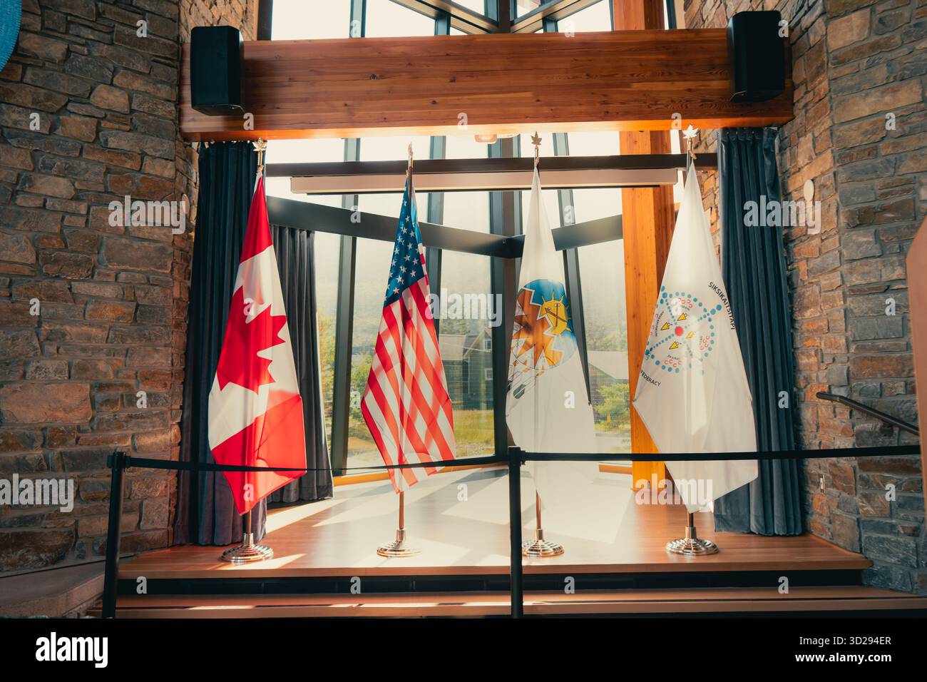 A display of national flags from multiple countries on display indoors ...