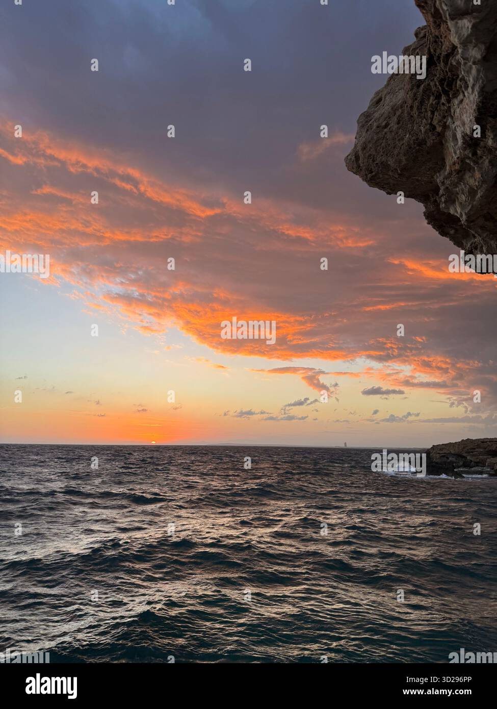 That moment when the clouds steal the show and the sea reminds you just how powerful nature is. The final, spectacular curtain call before the night - Smartphone Captured Stock Image