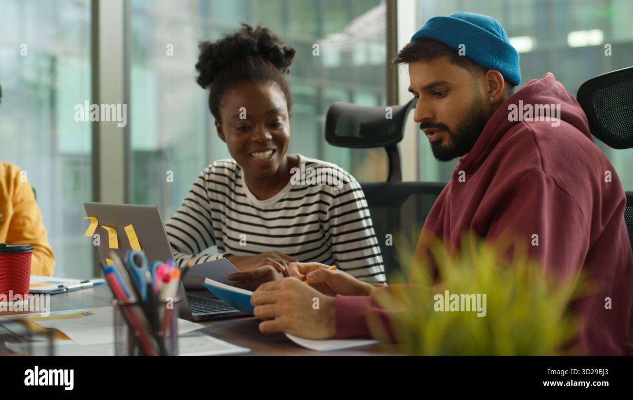 Multi-Ethnic entrepreneurs of informal business startup in office meeting diverse team work process in company workgroup, African American woman talk Stock Photo
