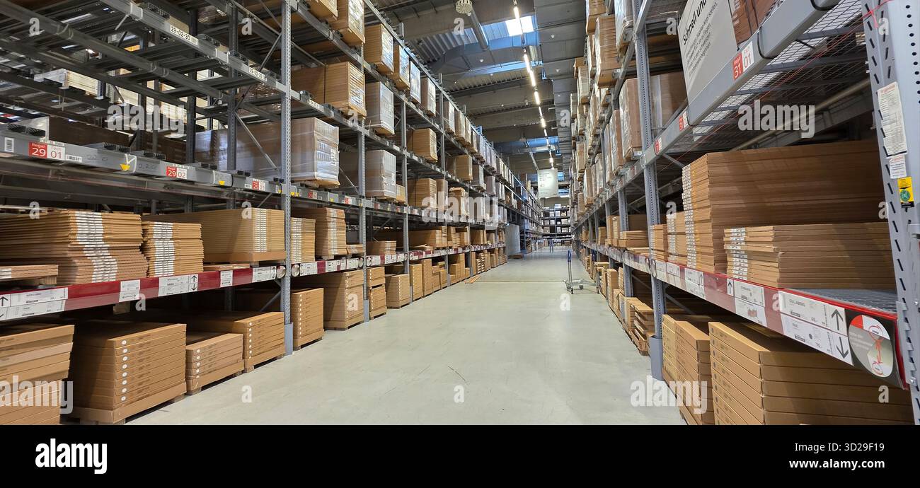 Berlin, Germany - May 05, 2025: Warehouse interior features neatly stacked boxes on shelves and spacious aisles. - Smartphone Captured Stock Image