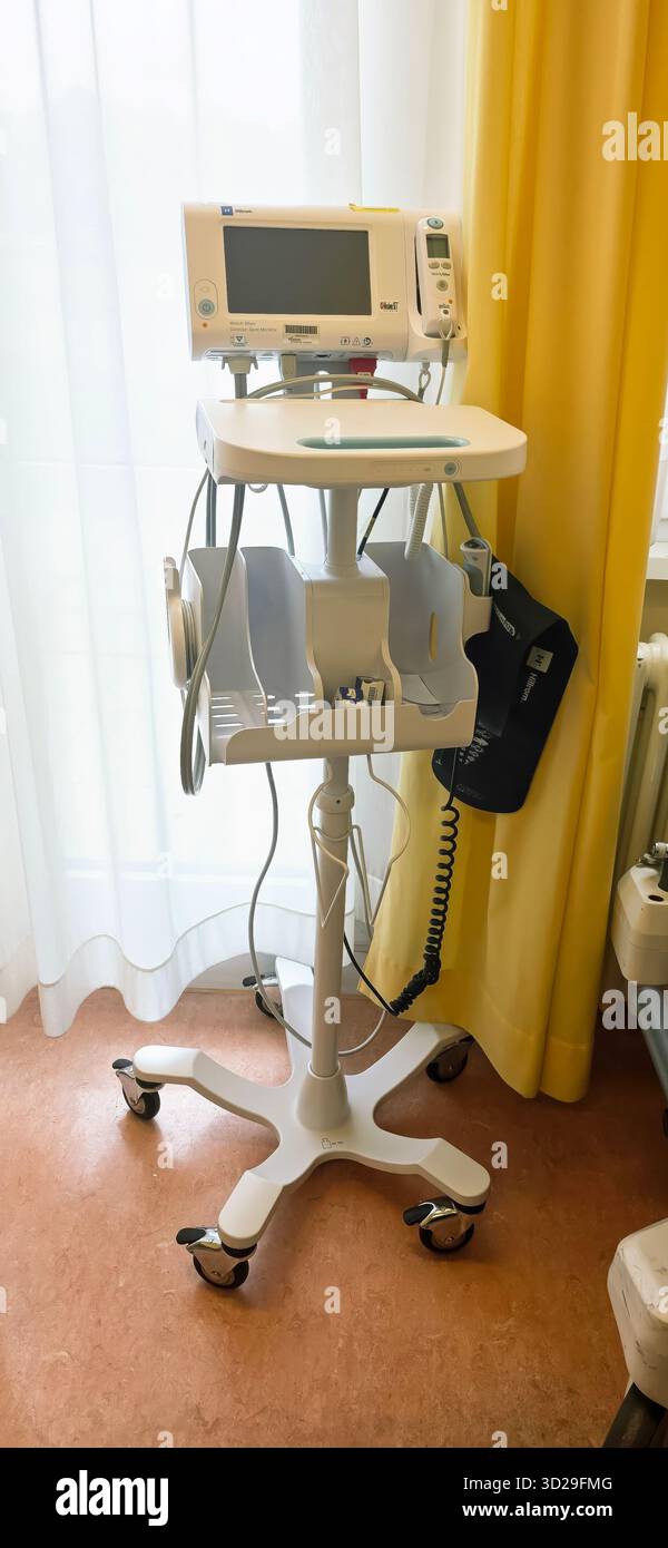 Berlin, Germany - June 16, 2025: Medical device on mobile cart in hospital room with bright window light. - Smartphone Captured Stock Image