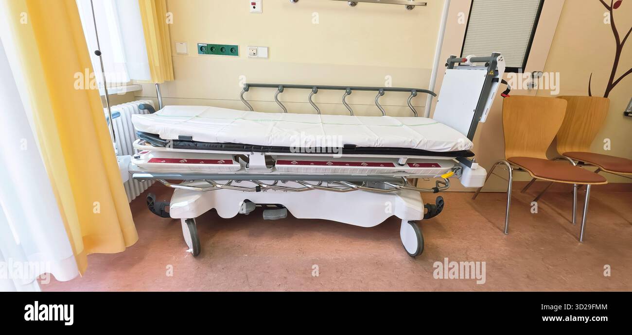Berlin, Germany - June 16, 2025: Hospital room features an empty patient bed with medical equipment and a chair. - Smartphone Captured Stock Image