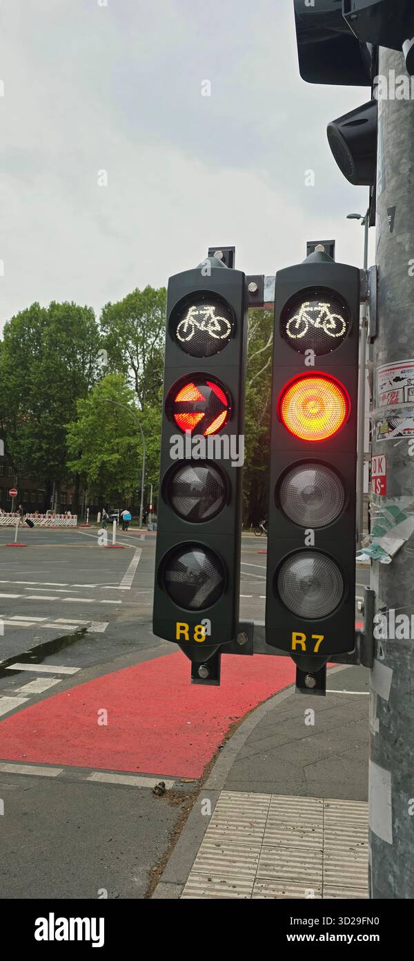 Belin, Germany - May 19, 2025: Traffic signal displays red light for vehicles and bicycle signal in urban environment. - Smartphone Captured Stock Image