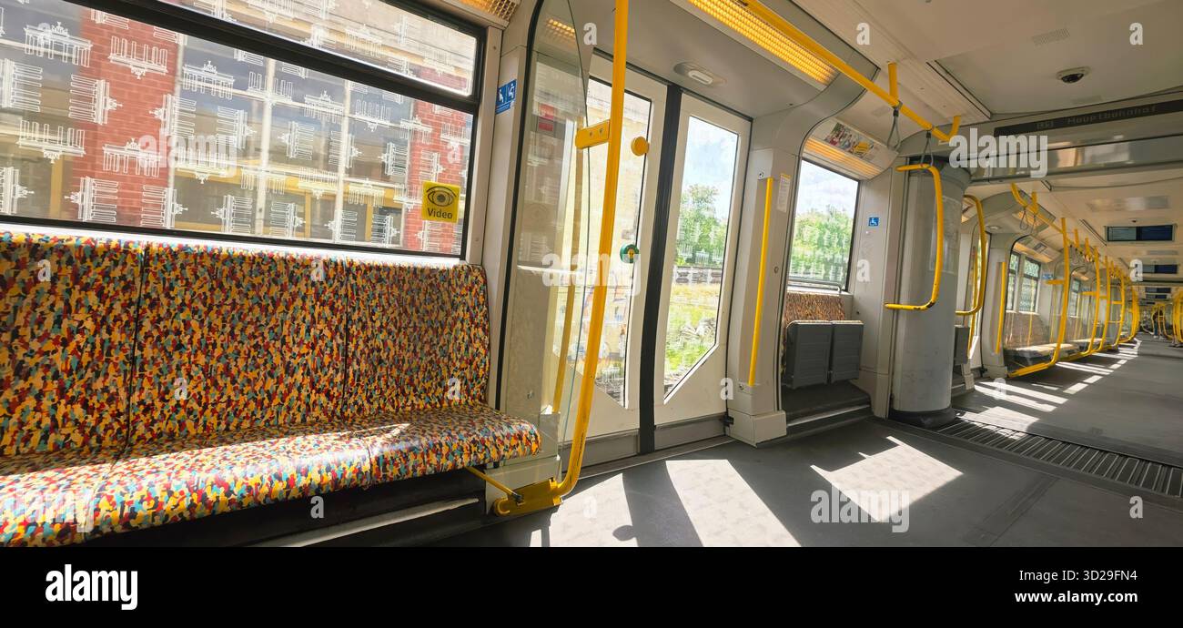 Berlin, Germany - May 22, 2025: Interior of a modern subway train featuring colorful patterned seats and bright lighting. - Smartphone Captured Stock Image
