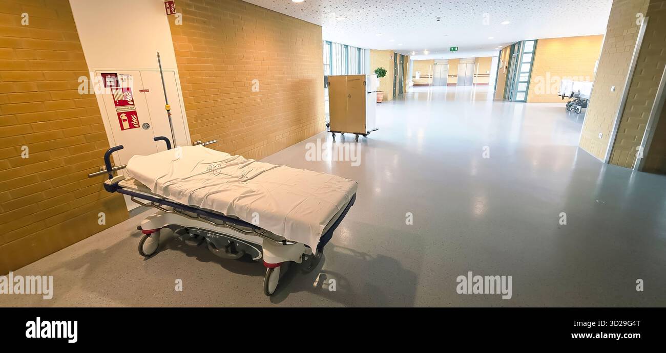 Belin, Germany - May 30, 2025: Hospital hallway features an empty stretcher and medical equipment in the background. Hospital - Smartphone Captured Stock Image