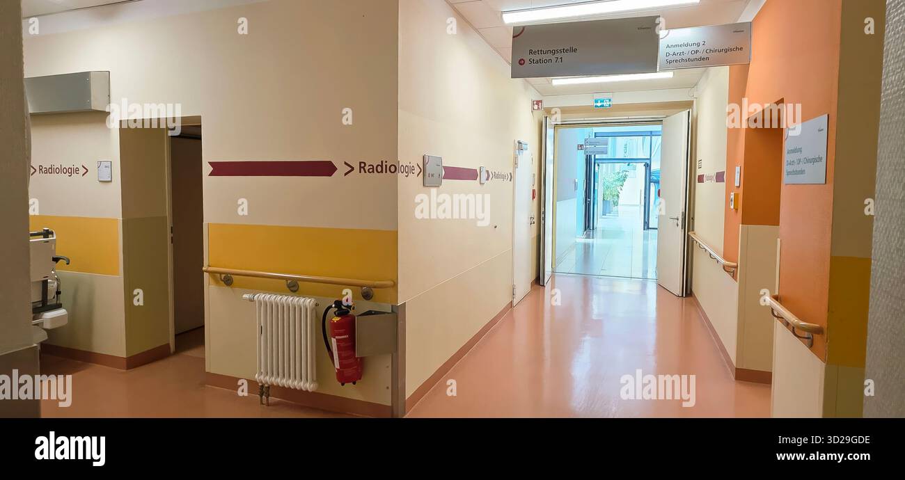 Berlin, Germany - June 16, 2025: Hospital corridor features directional signs and warm colors for patient navigation. - Smartphone Captured Stock Image