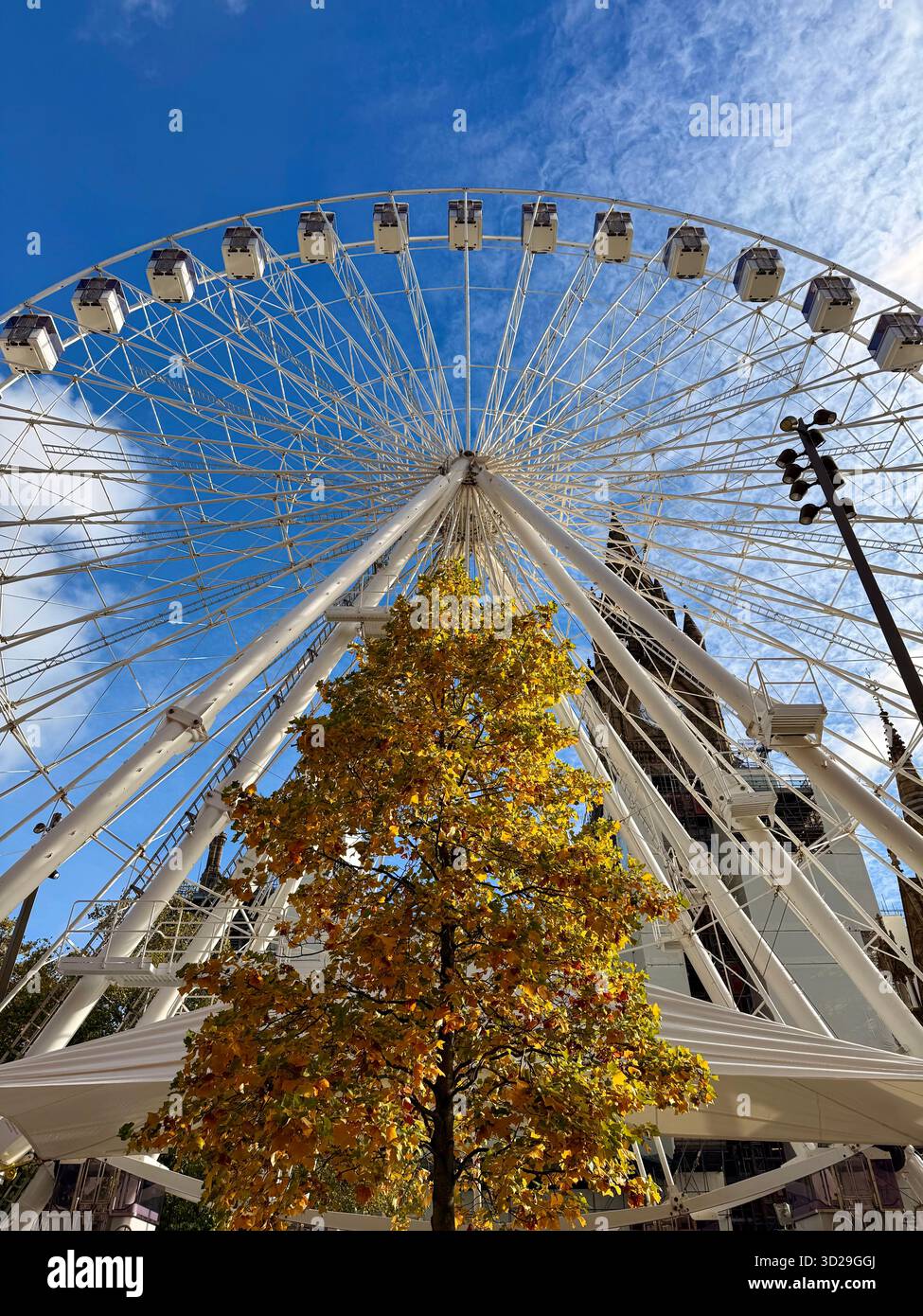Manchester City centre. Big ferris wheel and Autumn colours set up for Christmas markets in Albert Square. - Smartphone Captured Stock Image