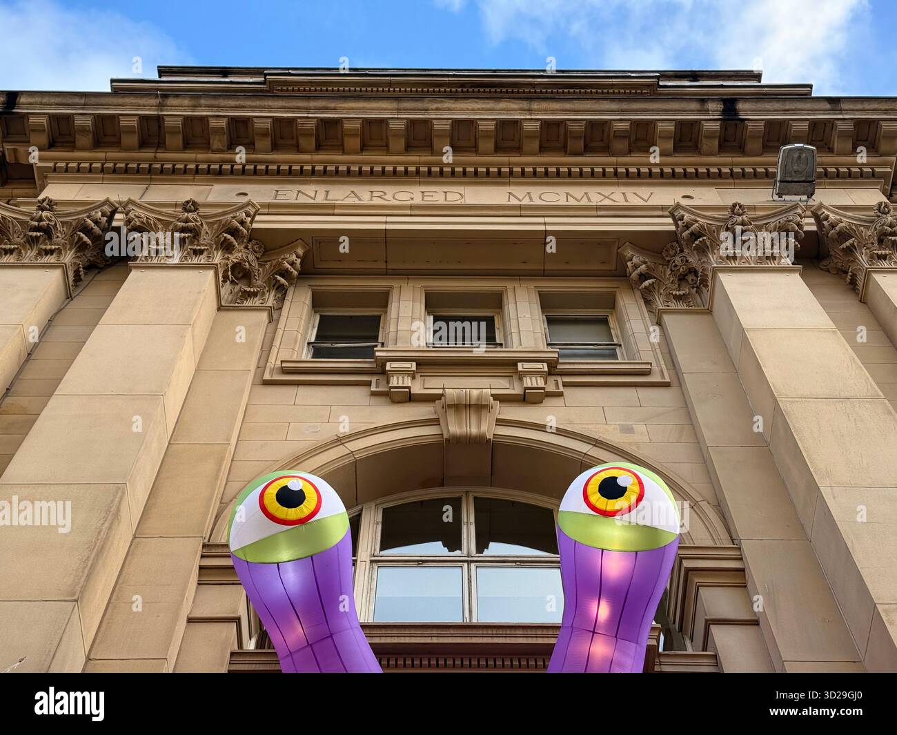 The Royal Exchange in St Anne’s Square, Manchester City Centre. Inflatable monster eyes outside shopping centre for Halloween - Smartphone Captured Stock Image