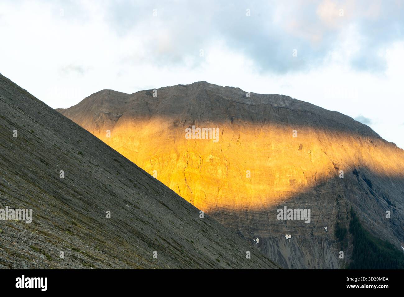 Sunlit mountain with rugged texture and dynamic light. Tent Ridge ...
