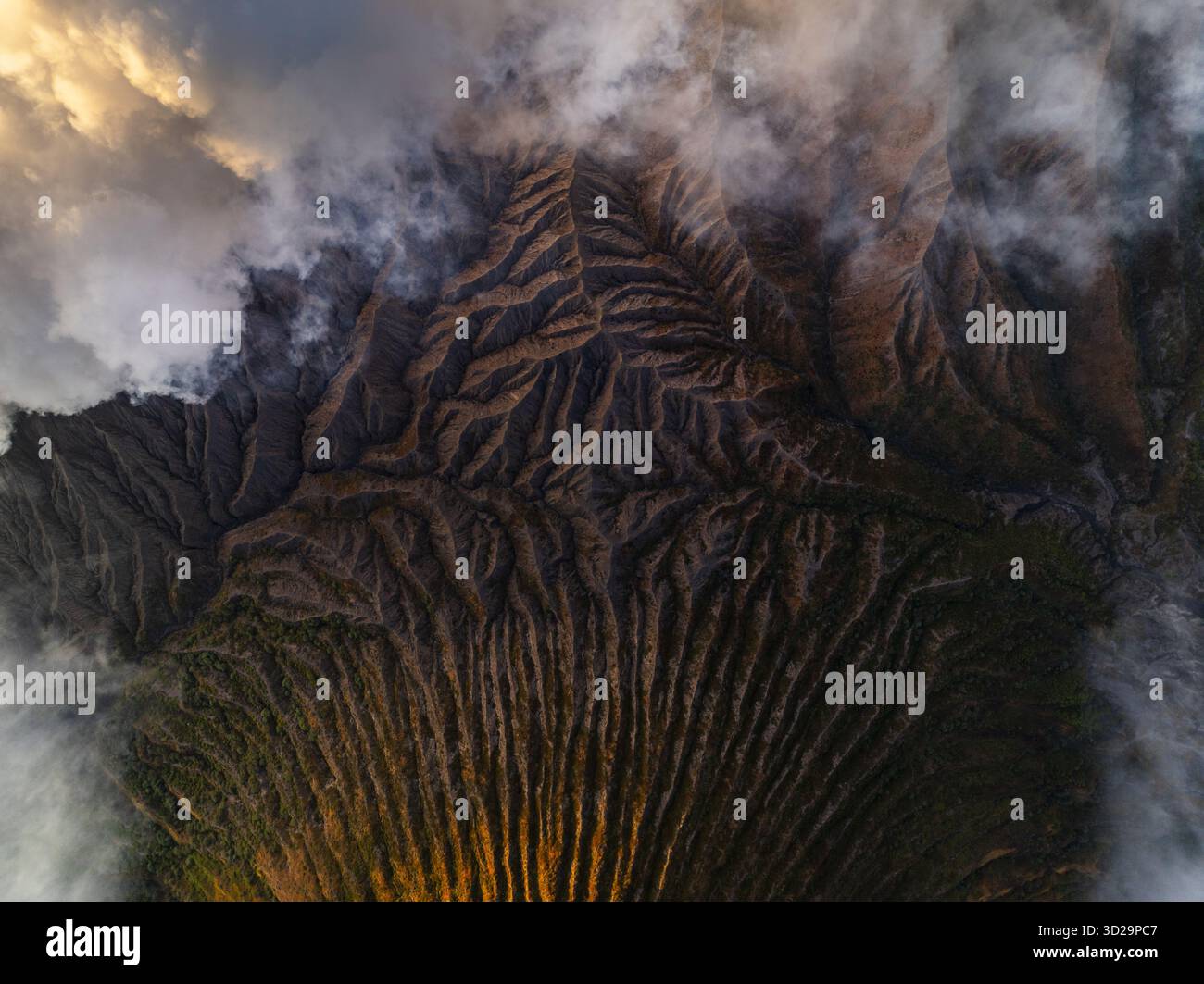 Aerial view of a rugged landscape with contrasting light and shadow ...
