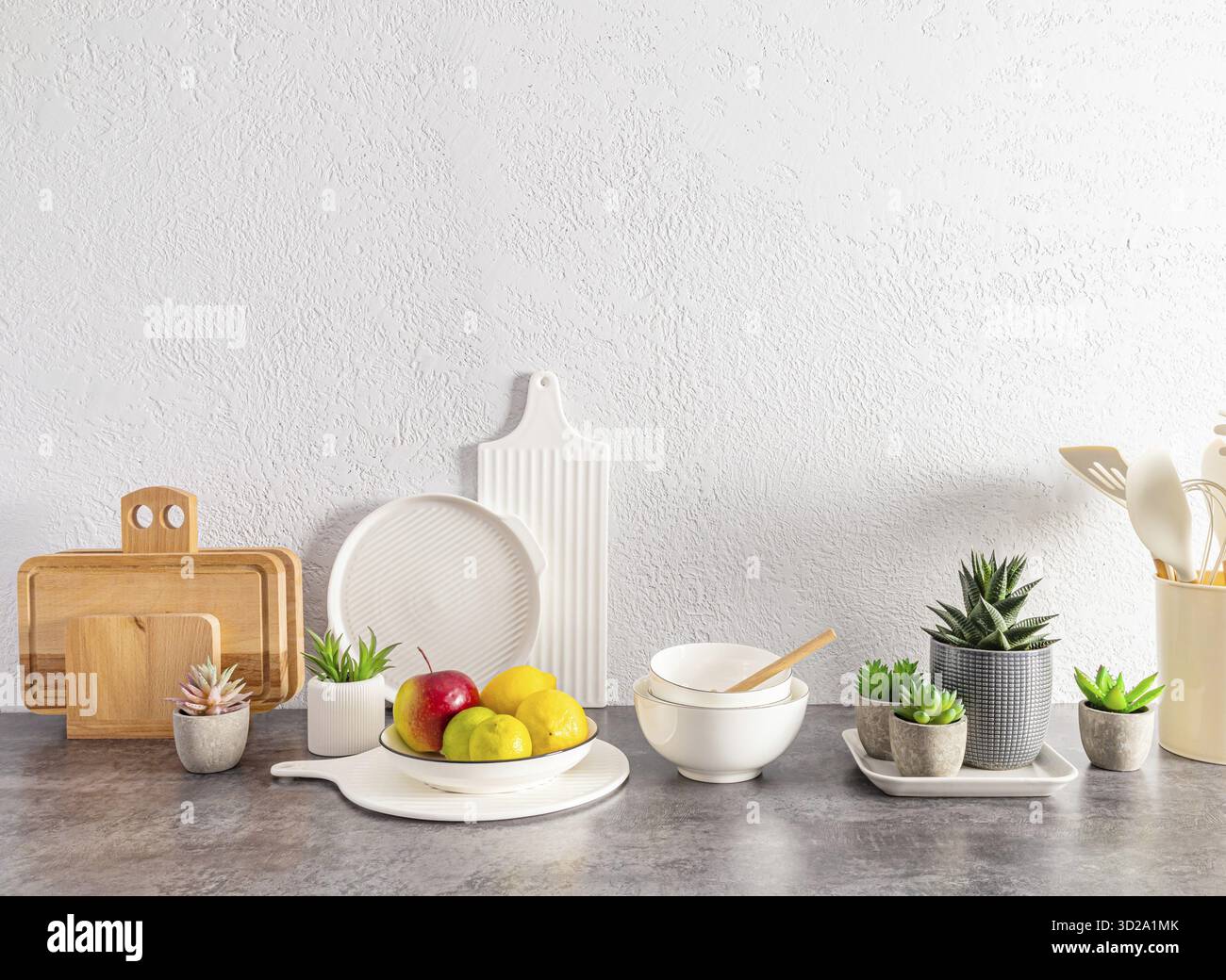 Beautiful kitchen background with a set of various environmentally friendly dishes, cutting boards, fruits in a bowl. space for text Stock Photo