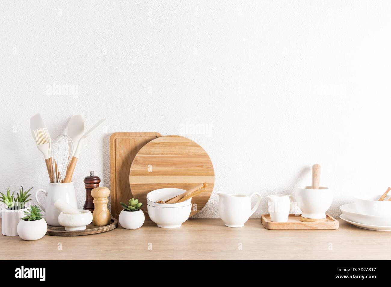 Various types of kitchen utensils on a wooden countertop at the ... - Zero Waste Apartment Countertop Ideas