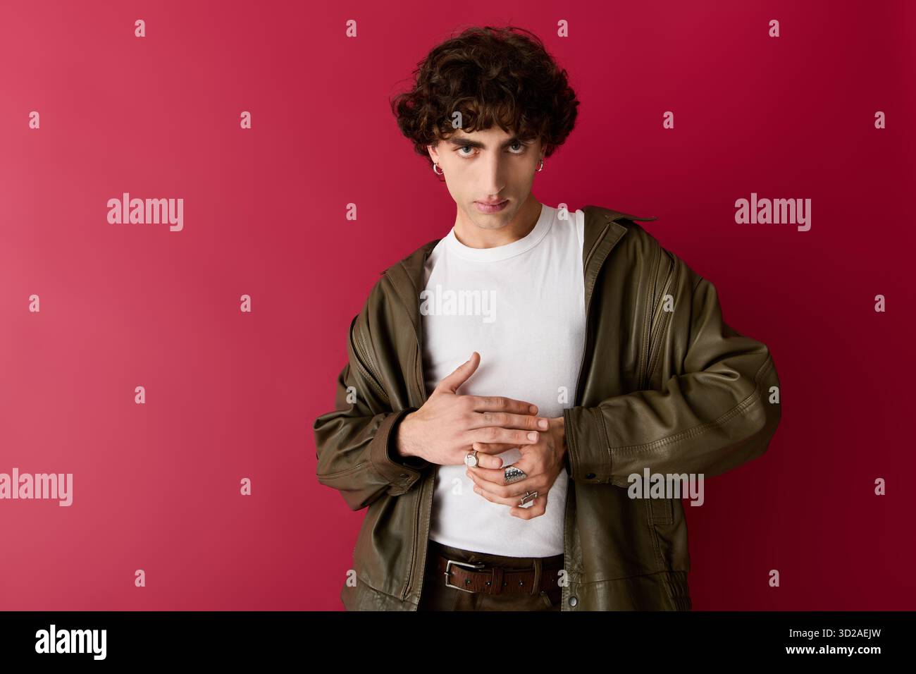 Stylish man poses elegantly against a bold background, showcasing ...