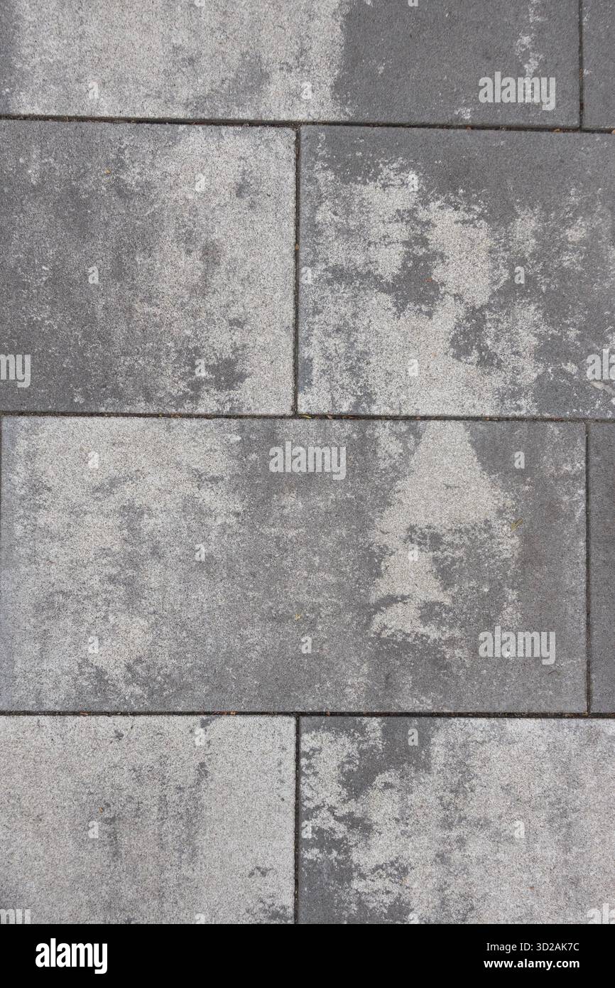 Grey stone pavement texture with irregular weathered patterns useful for background or design use Stock Photo