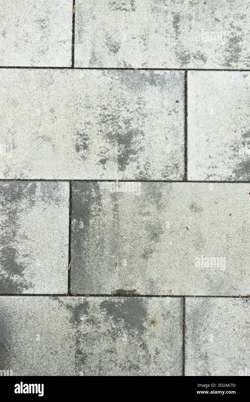 Grey stone pavement texture with irregular weathered patterns useful for background or design use Stock Photo