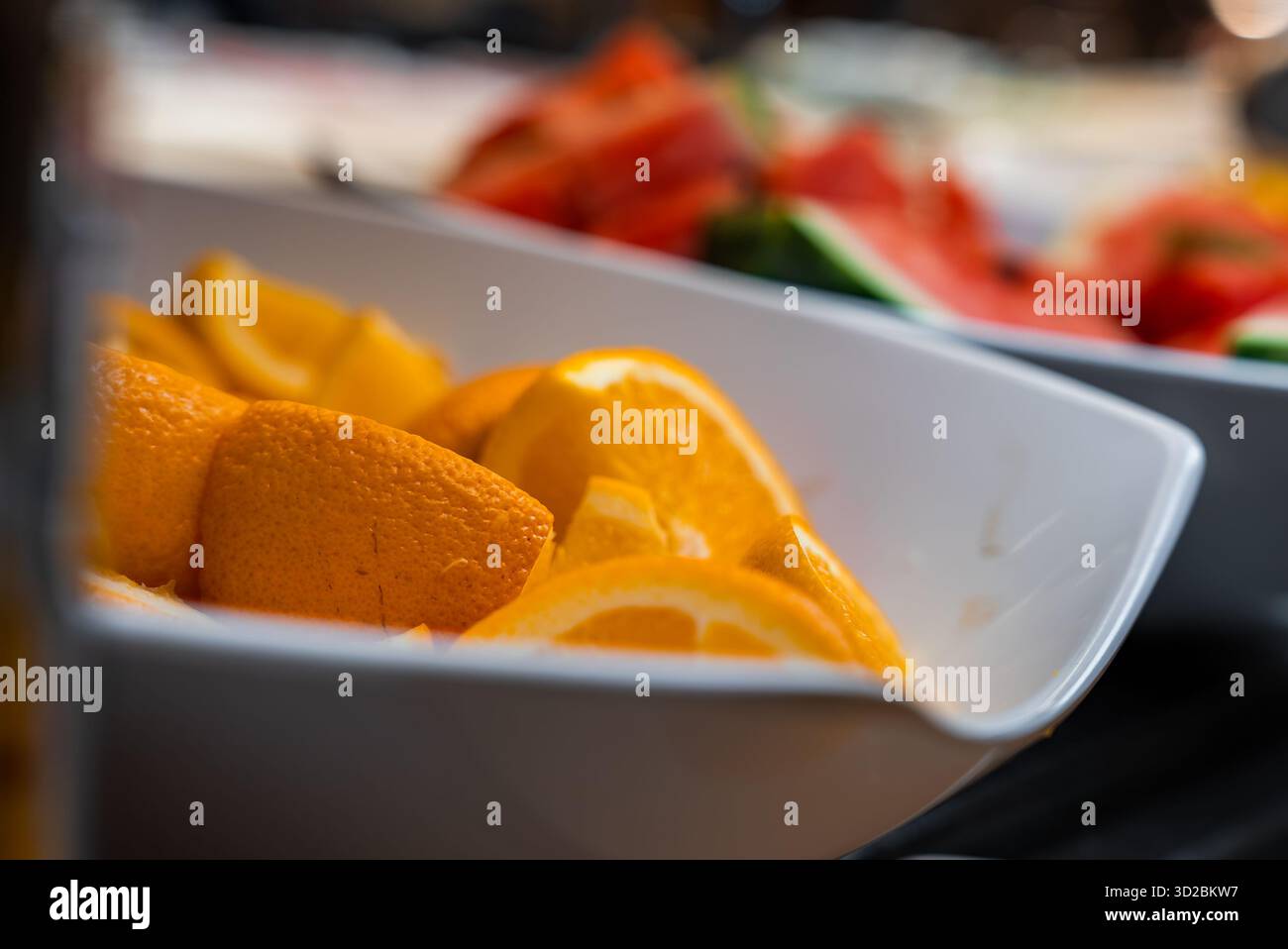 Orange wedges in shallow white dish at boutique hotel in Mellieha Stock Photo