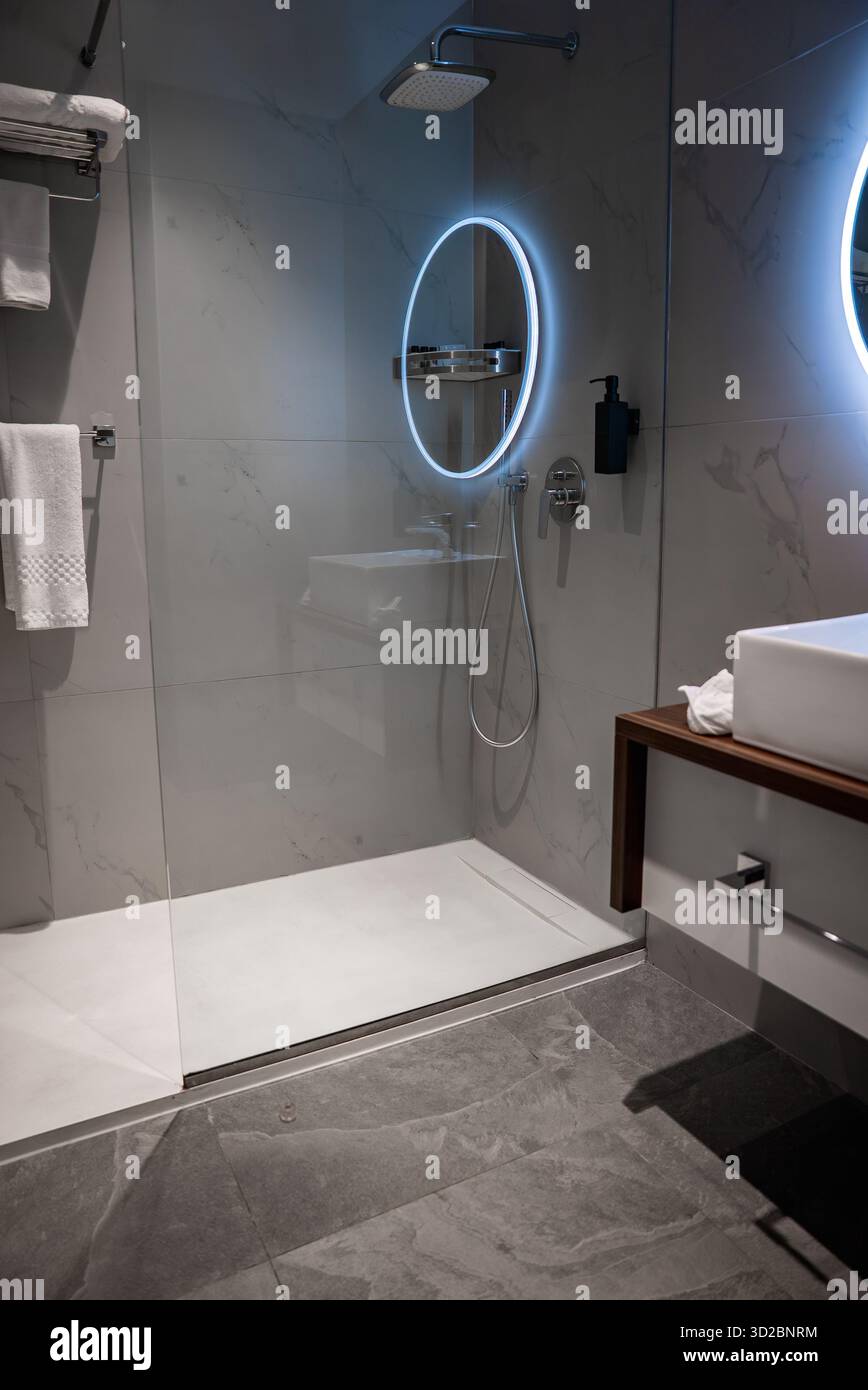 Contemporary hotel bathroom with walk in glass shower in Mellieha Stock Photo