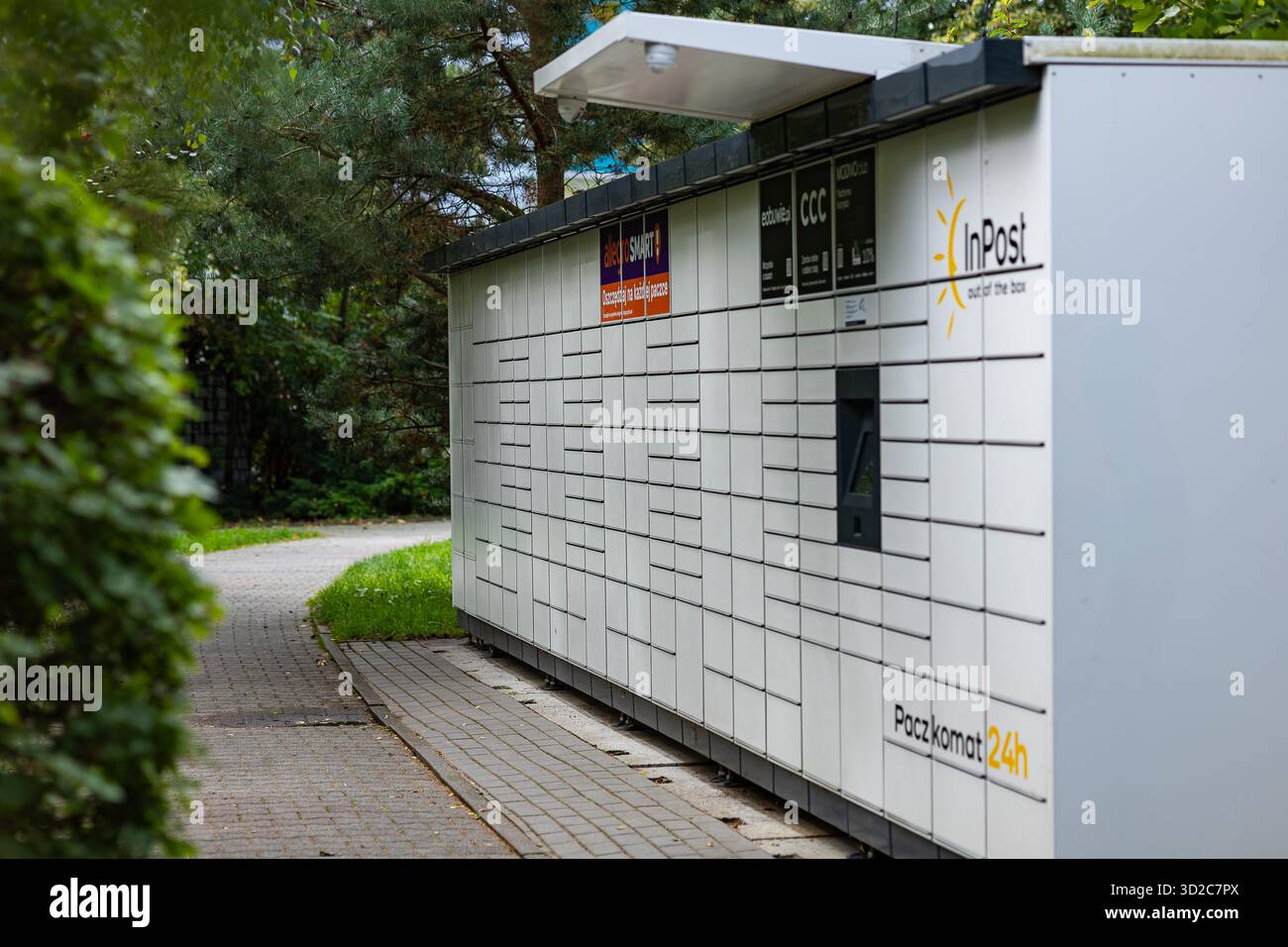 Modern parcel locker InPost located outdoors in a green park area ...