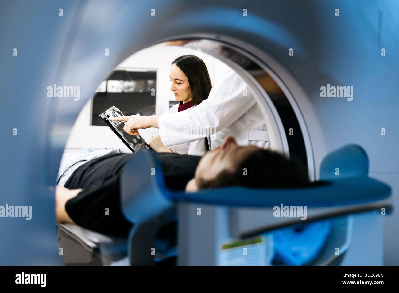 Medical expert discusses CT scan results with patient on examination ...