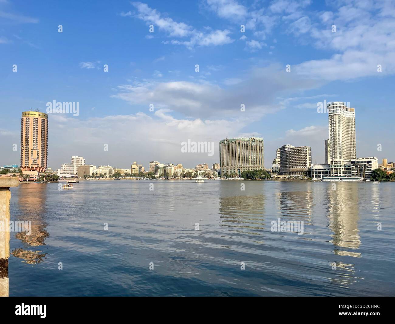 View of Downtown Cairo and Zamalek as seen across the Nile River from Giza, featuring the Four Seasons Hotel and Sofitel Gezirah in skyline, Egypt - Smartphone Captured Stock Image