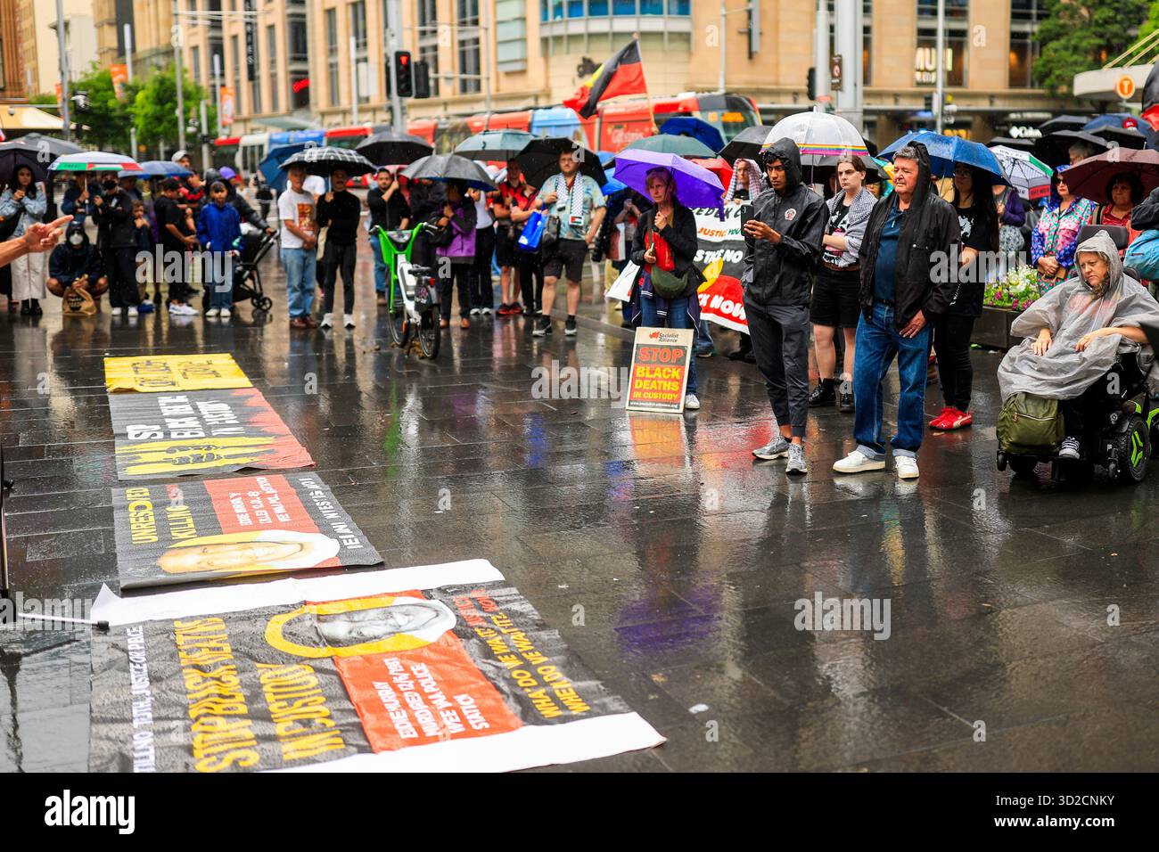 Protesters look on during speeches at the National Day of Action ...