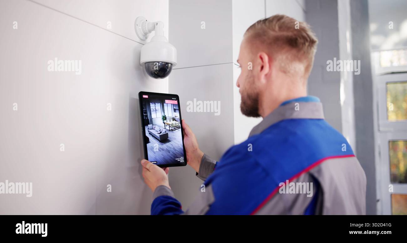 Security Technician Installing CCTV Surveillance System For Video Alarm Services. Stock Photo