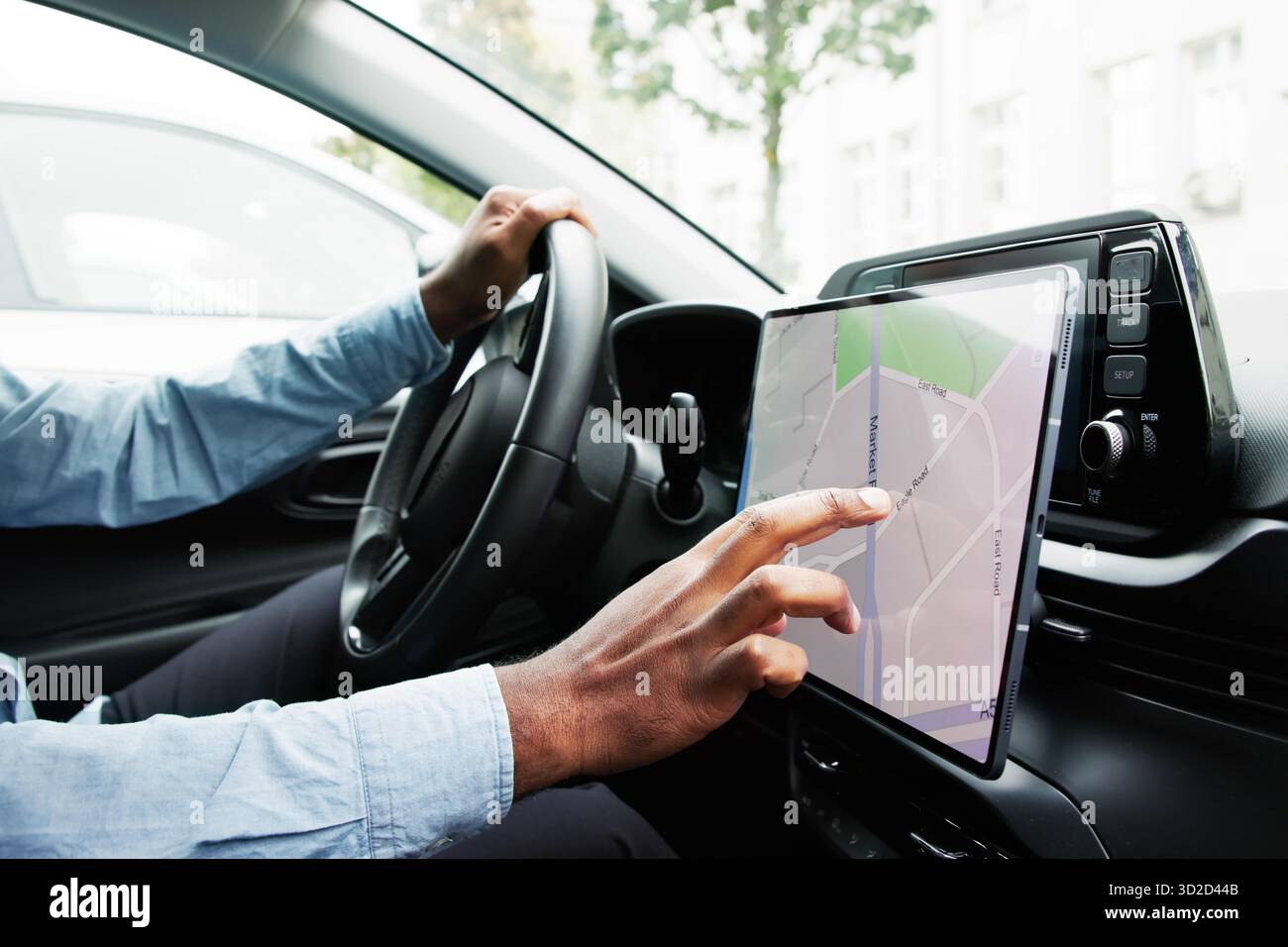 Driving Instructor Teaches Student How To Use Tablet For Navigation. Stock Photo