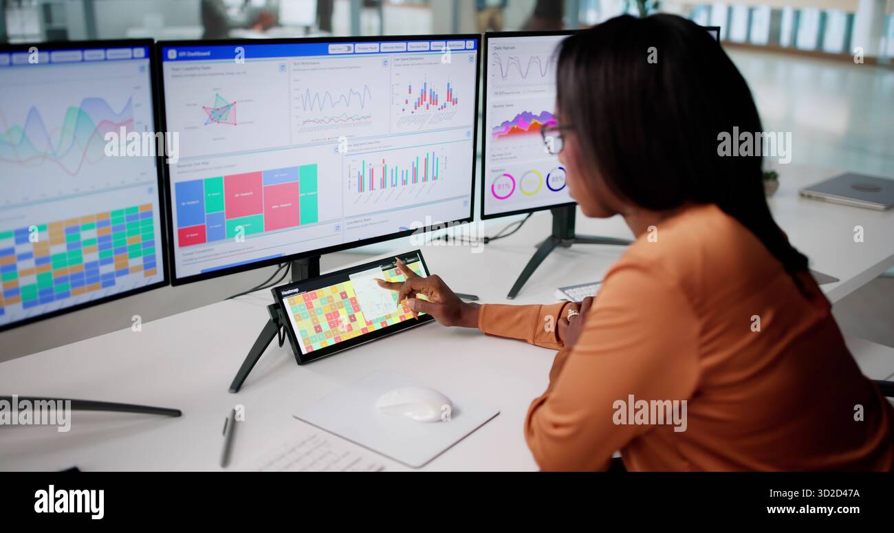 Remote Data Analyst Optimizing Efficiency With Heatmap Software At Office Stock Photo