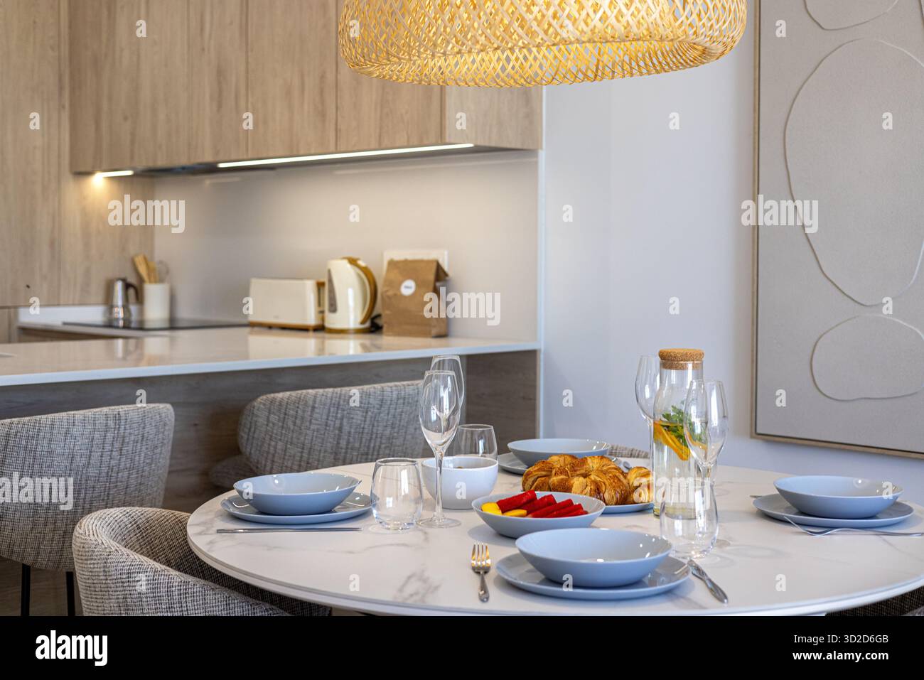 Elegant breakfast setup with croissants, fruits, and drinks in cozy ...
