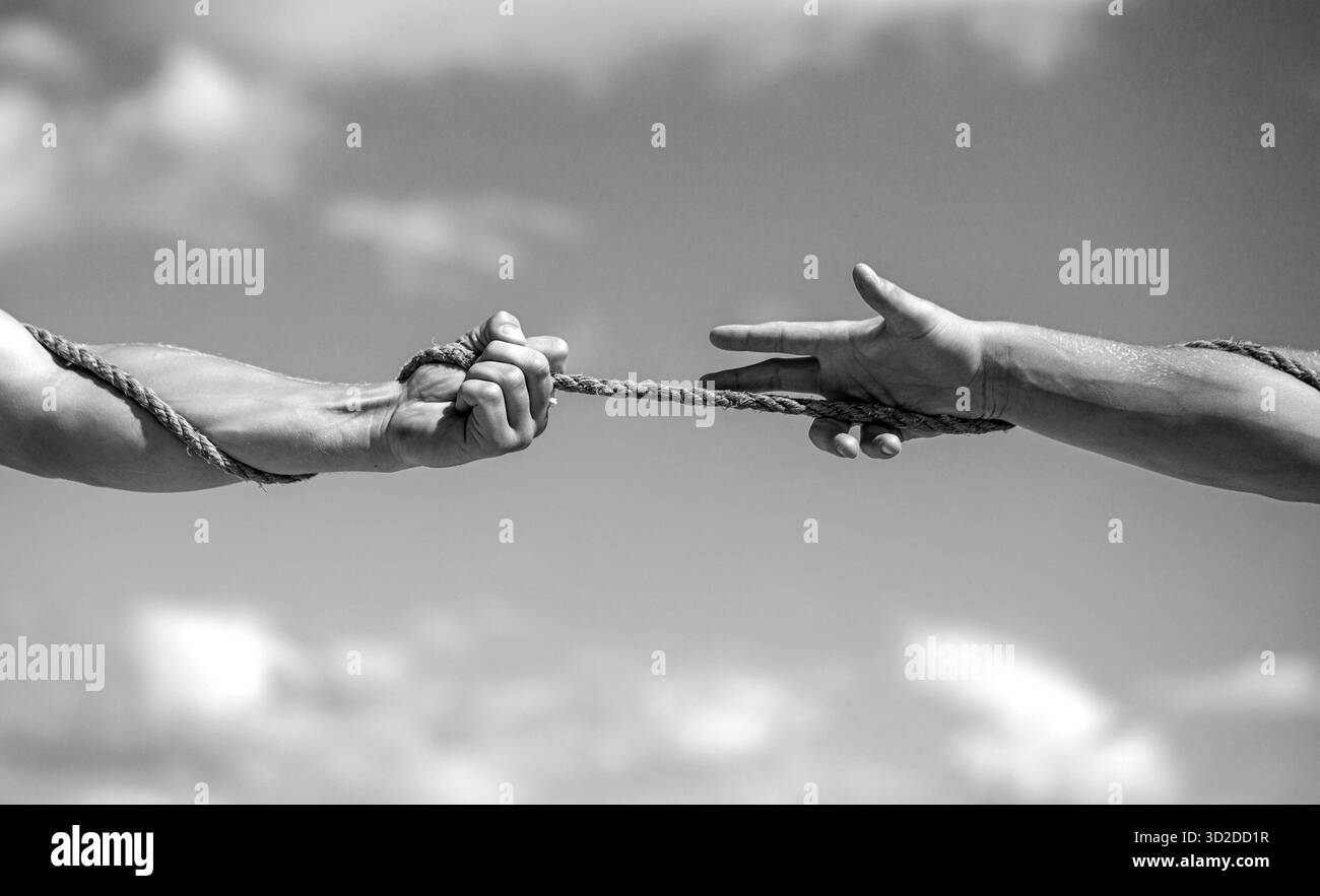 Two hands pulling rope Black and White Stock Photos & Images - Alamy