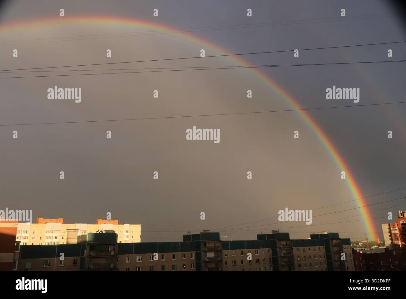 Rainbow after the rain over the houses of a residential area Stock ...