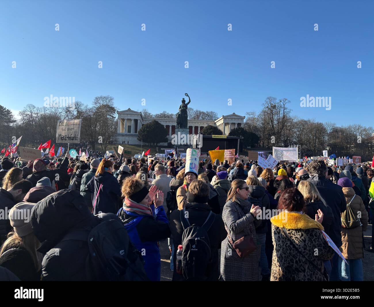 Protesters Rally in Front of Bavaria Statue on a Sunny Day in Munich, Germany - Smartphone Captured Stock Image