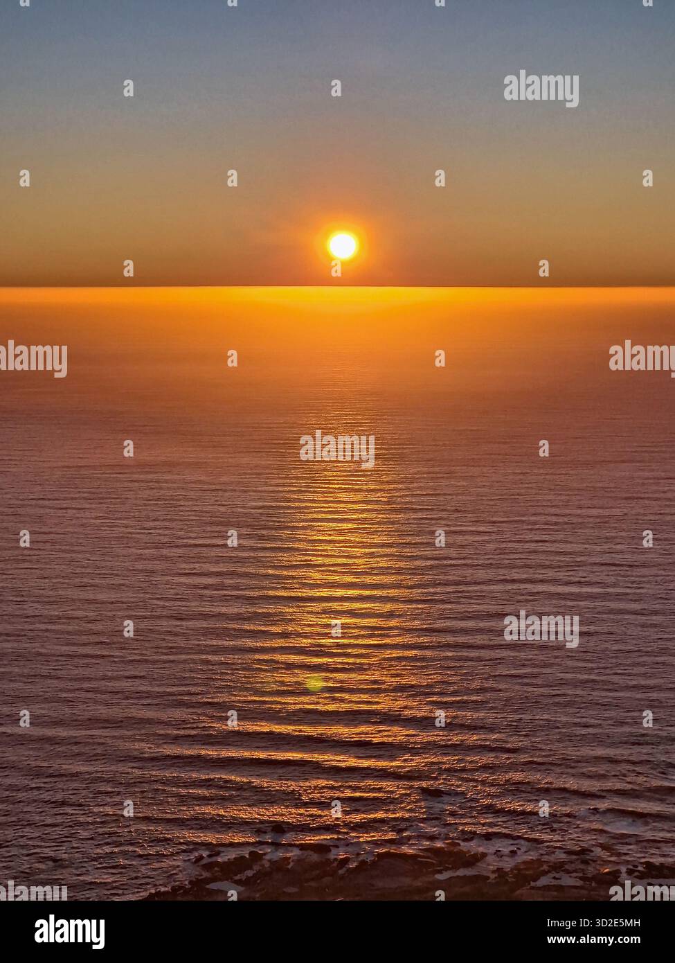 Sun setting on the horizon over the sea, Cape Town, South Africa - Smartphone Captured Stock Image