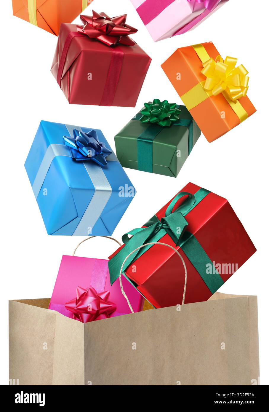 Many gift boxes falling into paper bag on white background Stock Photo